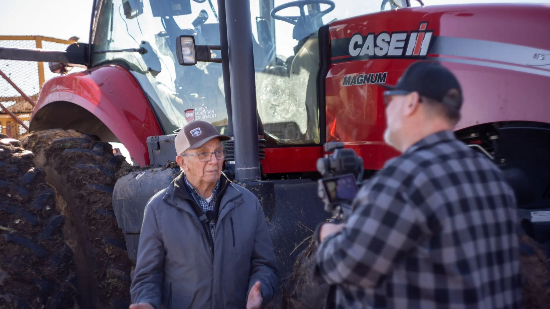 Interviewing a farmer beside his tractor on a Southern Alberta farm